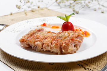 Crispy sizzling chicken steak on English wrapping paper