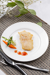 Japanese style grilled grouper on a placemat