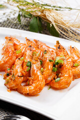 Sizzling South American shrimps on a plate placed on a placemat
