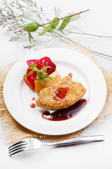 French Landes foie gras with red wine sauce on a straw mat
