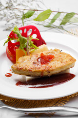 French Landes foie gras with red wine sauce on a straw mat