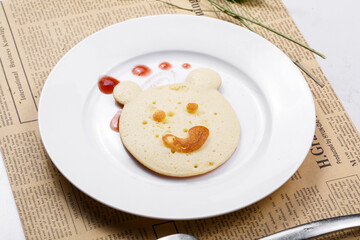 Blueberry jam bear biscuits are placed on English wrapping paper