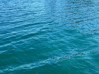 Blue water ripples calm surface.