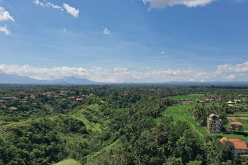 Obraz premium Panoramic View of Lush Balinese Hills and Canyons with Mountain Range in the Background
