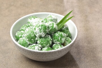 Klepon, also known as onde-onde, is a type of cake or steamed snack made from rolled sticky rice flour, filled with brown sugar and spread over grated coconut until it sticks.