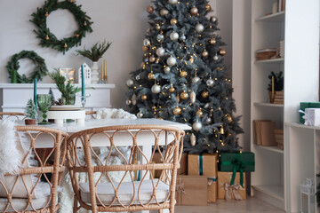 Dining table with candles and Christmas decor in light room