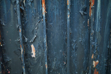 Rusty iron walls with paint beginning to peel. Brown rust. Deterioration over time. Wall.