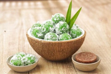Klepon, also known as onde-onde, is a type of cake or steamed snack made from rolled sticky rice flour, filled with brown sugar and spread over grated coconut until it sticks.