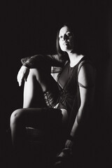 Sensual portrait of a woman with dark hair, done in a low key style.