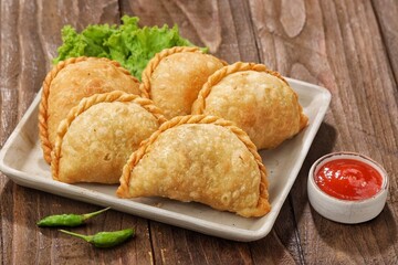 Pastel Goreng in Indonesia, pastel refers to a type of kue filled with meat, vegetables, and rice...