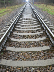 Railway track going into the distance. Vertical photo. Railway travel concept
