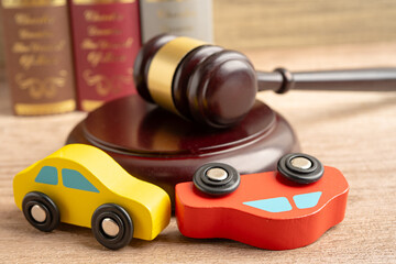 Hammer gavel judge with car vehicle accident, insurance coverage claim lawsuit court case.