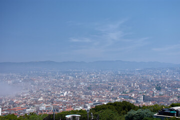 Aerial view of Marseille from the Notre Dame de la Garde observation deck with morning fog partially covering the city and skyline