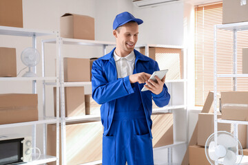 Male worker with tablet computer in warehouse