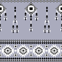 Black and white geometric ethnic boho seamless pattern on a grey background. Native ethnic pattern. Tribal pattern. Aztec-style. Textile rapport. Ideas for wallpaper, tiles, and elaborate borders.