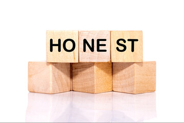 The concept word HONEST is assembled from cubes. Business integrity ethics honesty respect concept