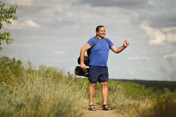 a man with a backpack goes on a journey in the summer