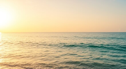 Fototapeta premium Creamy cream to tropical turquoise gradients with calm waves reflecting golden sunlight.