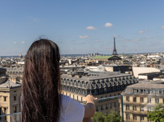 Girl looks at Paris from a viewing platform. Cityscape France, Paris