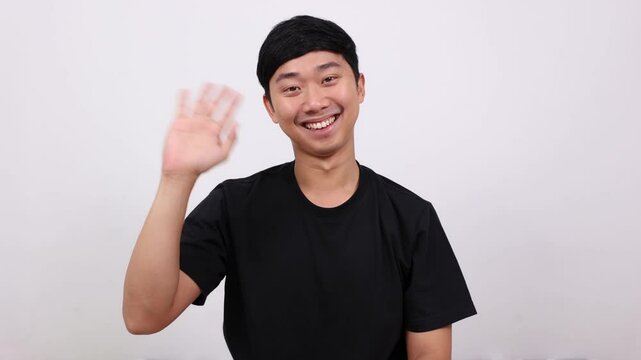 Asian man standing and show hand bye-bye, Man say good bye concept