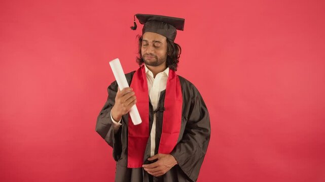 Degree holder smiles wide and gazes at his certificate
