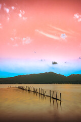 Landscape Series : Kwan Phayao with mountain view at sunset. Lake view with silhouette of the mountain range in the evening, Thailand. Beautiful sky and twilight before sunset.