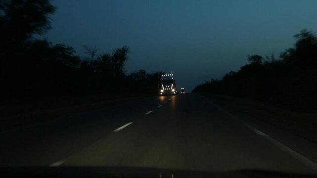Night traffic on the highway in Ukraine, view from the car on the highway with car headlights, driving