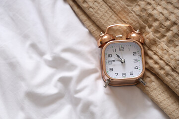 Alarm clock on bed, top view