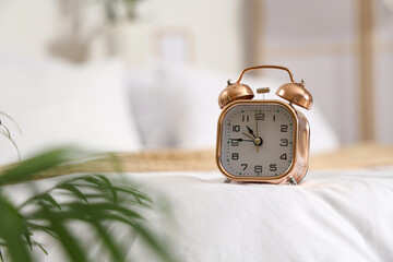 Alarm clock on bed in bedroom, closeup