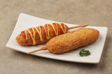 Corndog is a food made from skewered sausages (usually hot dogs) coated in a thick layer of cornmeal and fried.