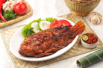 Ikan Bakar. Grilled fish is a fish dish that is grilled or roasted over a fire or embers.