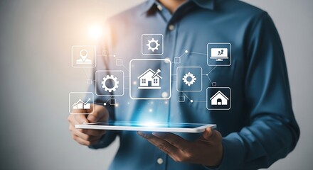 A professional man in a blue shirt holds a tablet displaying a futuristic interface with icons related to smart homes and data