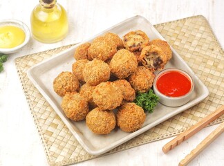Bitterballen is the name of a type of food in the Netherlands. Bitterballen taste similar to...