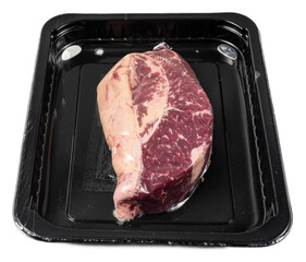 Fresh marbled boneless beef ribeye steak with rich red color and tender textures isolated on black...