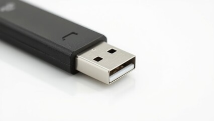 Close-up of a USB drive showcasing its metallic connector and sleek design against a white background.