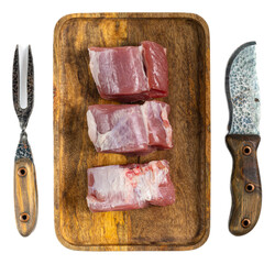 Raw pork fillet medallions on wooden cutting board with carving knife and meat fork, fresh butcher...