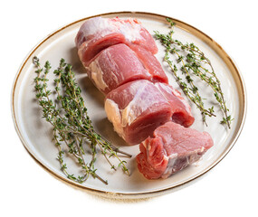Fresh raw pork fillet medallions with sprigs of thyme on a rustic ceramic plate, highlighting tender meat cuts with natural textures and pink hues, ideal for culinary preparation and meat selection