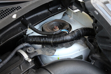 Front Suspension Cup. View of the car suspension strut cup in the engine compartment open hood. Front Suspension Shock Absorber Cup. 