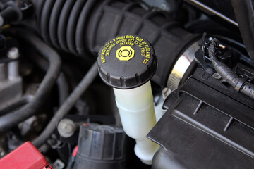 Brake fluid reservoir of brake system in the car. Brake fluid reservoir cap under the hood of a...