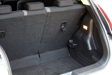 Open back door white modern SUV. Modern SUV trunk. Close up car trunk. Modern vehicle have an open...