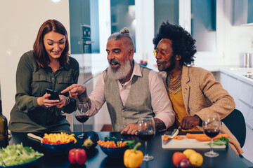 Diverse friends enjoying cooking and socializing together