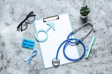 Male sign with clipboard, ribbon, stethoscope and eyeglasses on grey grunge background. Prostate...