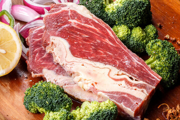 Beef belly brisket on wooden cutting board