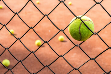 Tennis Ball in Chain Link Fence Court View, Sport, and Challenge