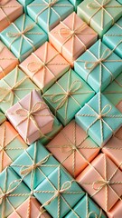 A collection of small pastelcolored gift boxes tied with gold string, arranged in a repeating pattern