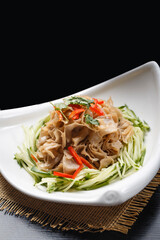 Cold oat noodle soup in a white porcelain plate