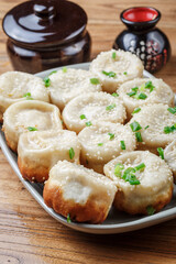 Shanghai style pan-fried buns on a porcelain plate
