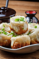 Shanghai style pan-fried buns on a porcelain plate