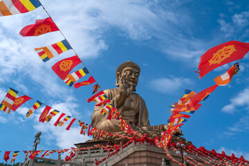 The Great Buddha Statue in the Nanshan scenic area of the Jiaodong Peninsula on a sunny summer day,...