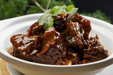White casserole with fragrant sauce and oxtail bones